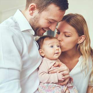 Parents holding happy baby