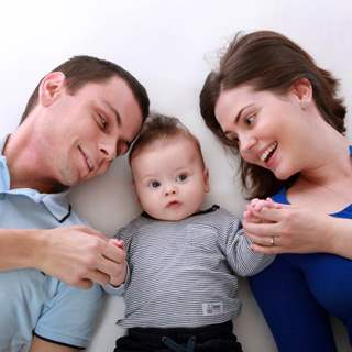 Couple with baby lying down