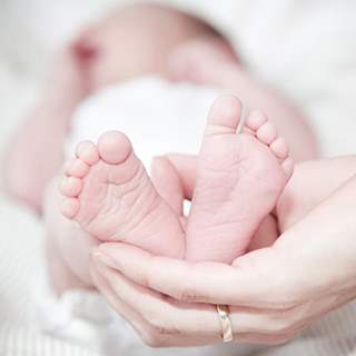 Baby's feet in hand