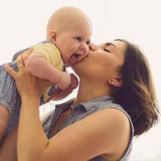 Mother kissing baby
