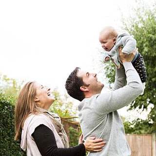 Parents with baby in garden