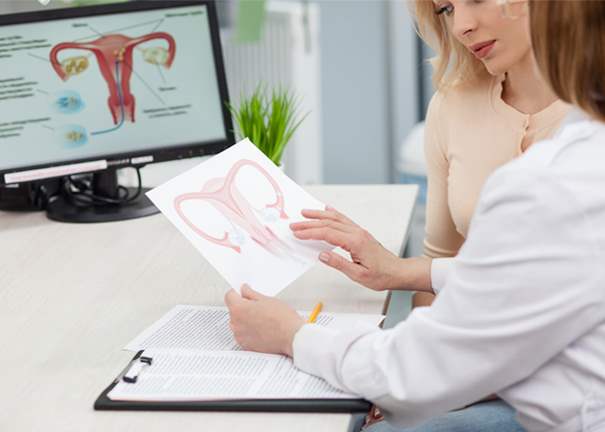 Woman and doctor looking at womb illustration